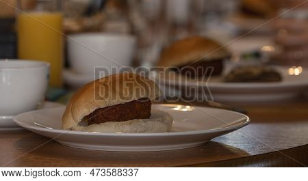 Traditional White Bun With A Dutch Kroket , Called Broodje Kroket On A Lunch Table