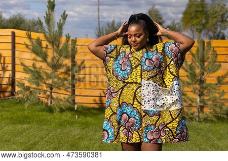 Portrait Of Beautiful African American Woman Having Fun On Village Or Suburbian. Outdoor Portrait Of