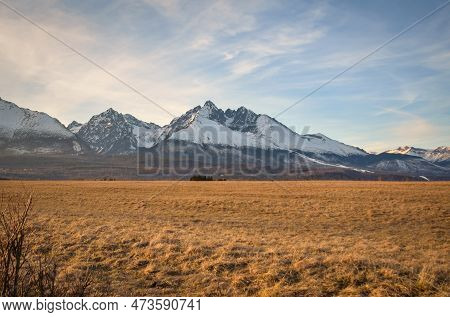 Beautiful, Mountainous, Spring Panorama. White Snow-covered Peak In The Slovak Tatra Mountains. Phot