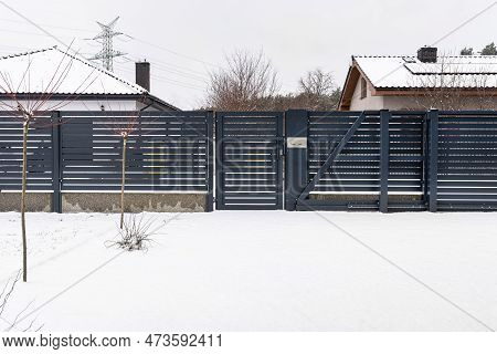 Modern Panel Fence In Anthracite Color, Visible Sliding Gate And Wicket With Letterbox In Winter.