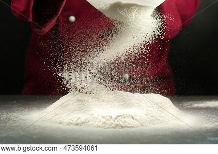 Sifting Flour. Chef Sifts Flour Through A Sieve.
