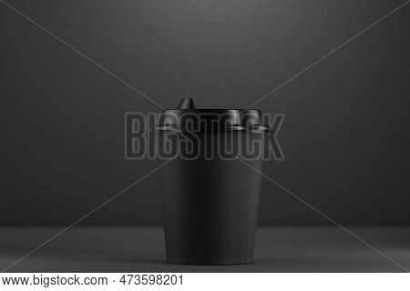 Black Disposable Machine With A Plastic Lid On A Black Background. Black Disposable Cup Mockup. Blac