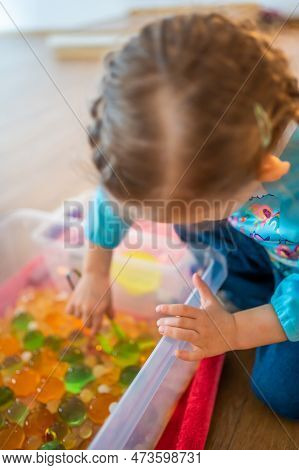 Little Girl Playing With Sensory Water Beads, Hydrogel Balls. Sensory Development And Experiences, T