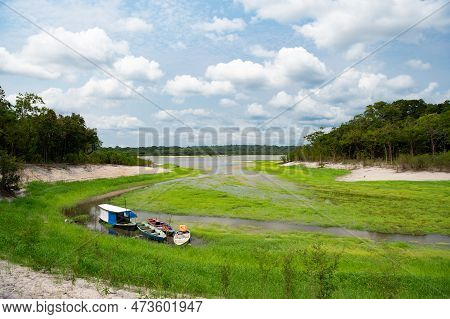Rowboat At Riverside Nature, Copy Space. Wooden Rowboat At Riverside. Landscape With Rowboat
