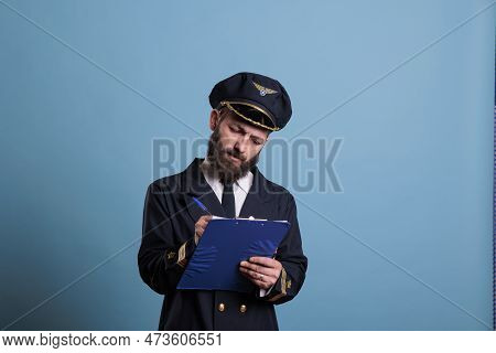 Airplane Pilot Holding Clipboard, Writing, Concentrated Aviator With Documents. Aircraft Captain In 