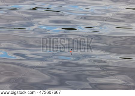 Beautiful View Of Fishing Float On Mirror Water Surface.