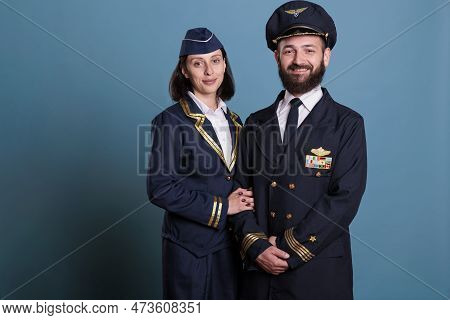 Smiling Airplane Captain And Flight Attendant In Professional Cabin Uniform Studio, Medium Shot Port