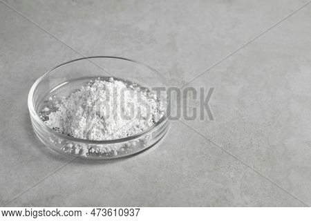 Petri Dish With Calcium Carbonate Powder On Light Grey Table. Space For Text