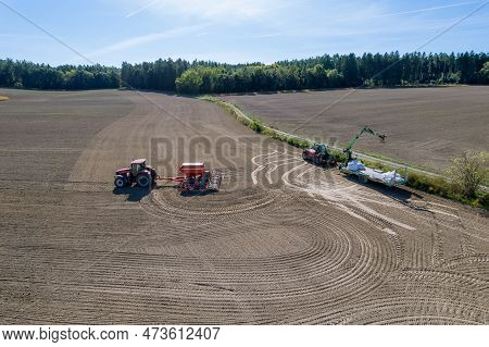 Sowing Grain In The Field, The Tractor Sows Grain With The Help Of A Seeder. Top View.