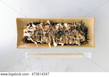 Gyuhei Yaki, Stir Fried Vegetable Wrapped With Egg And Meat On Ceramic Plate Place Next To Bamboo Ch