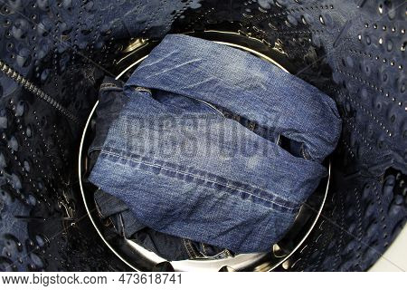 Blue Jeans In A Washing Machine. Close-up.