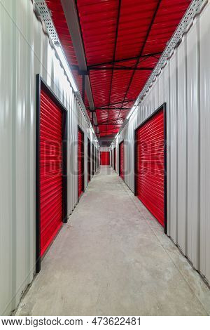Corridor Of Self Storage Unit With Red Doors. Rental Storage Units