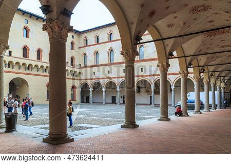 Milan, Italy - May 10, 2018: These Are Unidentified Tourists In The Courtyard Of The Medieval Fortre