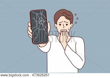 Man Reacts Emotionally To Broken Phone By Bringing Hand To Mouth And Experiencing Shock Due To Break