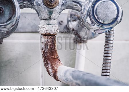 Close Up Of Old Rusted Faucet. Toned Photo Of Old Tap Covered In Rust, Lime And Calx