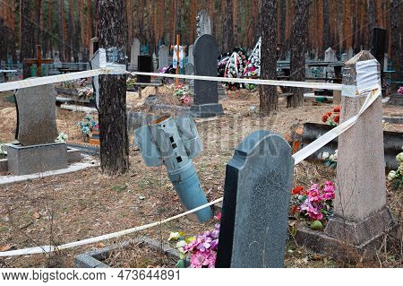 Unexploded Rocket Fenced For Safety With Warning Tape Can Be Seen In The Cemetery Of Izyum, Kharkiv 