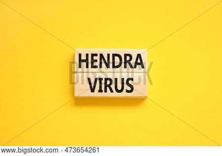 Hendra Virus Symbol. Concept Words Hendra Virus On Wooden Block. Beautiful Yellow Table Yellow Backg