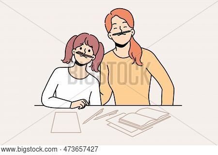 Smiling Mother And Daughter Have Fun Doing Homework Together At Home. Happy Mom And Girl Child Feel 