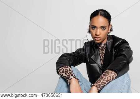 Stylish African American Woman In Trendy Clothes And Hoop Earrings Isolated On Grey.