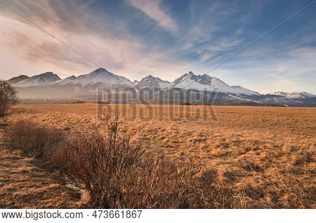 Beautiful, Mountainous, Spring Panorama. White Snow-covered Peak In The Slovak Tatra Mountains. Phot