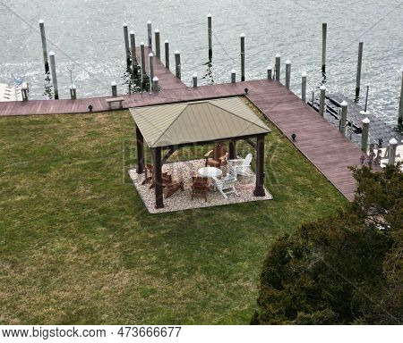 Drone View From Above Of A Gazebo In A Backyard On The Water With Bulkhead And Pylons.