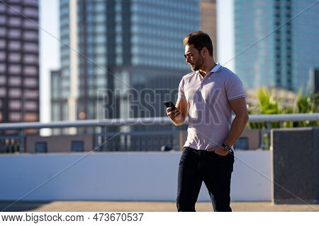 Casual Handsome Man Chatting On Phone In Urban City. Well-dressed Man Talking On Phone Outdoor. Busi