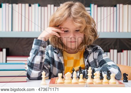 Play Chess. Chess School. Child Think About Chess Game. Intelligent, Smart And Clever School Kid Pup