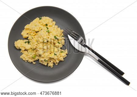 Top View Of Scrambled Eggs With Fresh Green Chives On Dark Grey Plate With Elegant Cutlery Isolated 