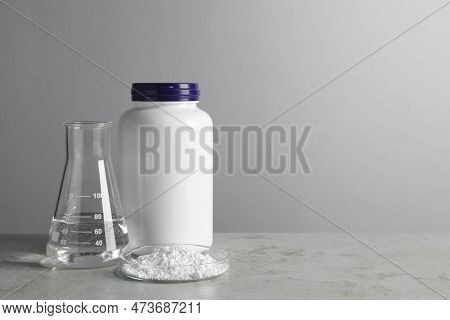 Petri Dish With Calcium Carbonate Powder, Jar And Laboratory Flask On Light Grey Table. Space For Te