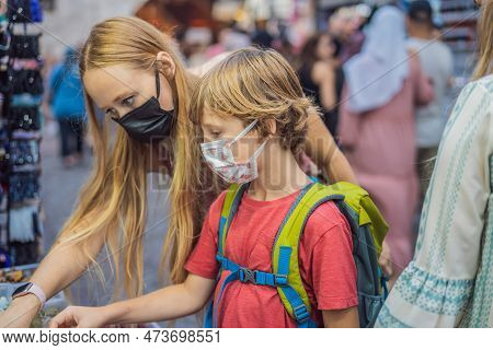 Mother And Son Tourists Walks Among The Countless Shops At The Grand Bazaar And Egyptian Bazaar In I