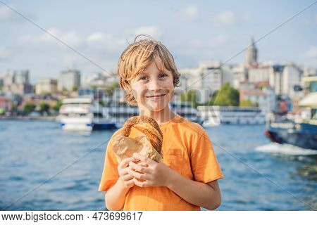 Boy In Istanbul Having Breakfast With Simit And A Glass Of Turkish Tea. Glass Of Turkish Tea And Bag