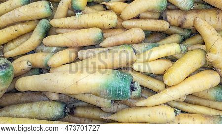 Many Fresh Carots Green Yellow Variety For A Background Texture  In Market