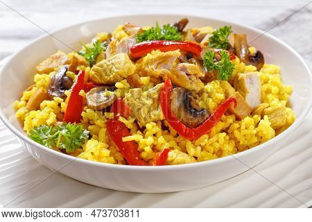 Chicken Paella Of Arborio Rice, Chicken Fillet, Mushrooms, Julienned Bell Pepper And Spices In White