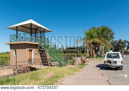 Keimoes, South Africa - Feb 25, 2023: A Viewpoint, Irrigation Canal, Waterwheel And A Vehicle, In Ke