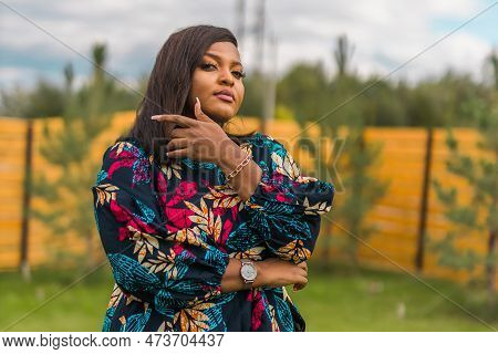 Portrait Of Beautiful African American Woman Having Fun On Village Or Suburbian. Outdoor Portrait Of