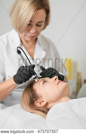 Rejuvenating Facial Therapy Treatment At Spa Salon Clinic. Young Beautiful Woman Getting Lifting Ant