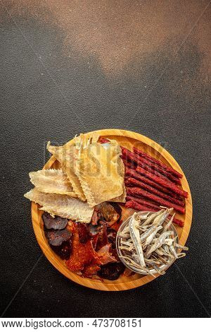Variety Of Dried Fish, Snacks For Beer On A Dark Background. Vertical Image. Top View. Place For Tex