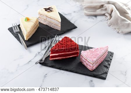 Set Of Cake Portions, Velvet, Strawberry Cake, Carrot Cake And Chocolate Cake On Marble.