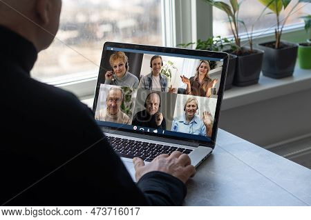 Man Working From Home Having Online Group Videoconference On Laptop.