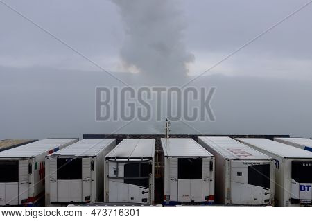 Transport Trucks Aboard Stena Line Ferry. Smoke From The Ship And Clouds In Background. Hook Of Holl