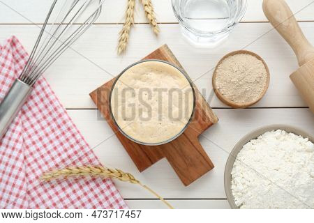 Leaven, Flour, Water, Rolling Pin, Whisk And Ears Of Wheat On White Wooden Table, Flat Lay