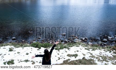 Happy Woman Enjoying On Czarny Staw Pod Rysamy Or Black Pond Lake Near The Morskie Oko Snowy Mountai