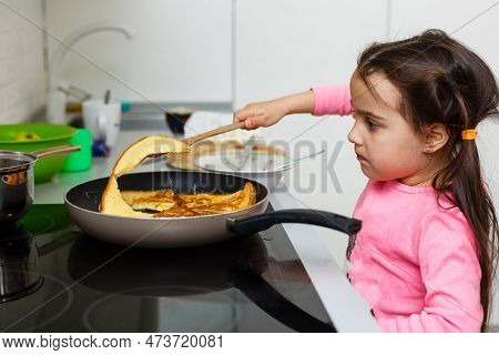 Little Beautiful Girl In Powdery Dress Sits Behind Straw In The Kitchen And Looks Away, Close-up, In