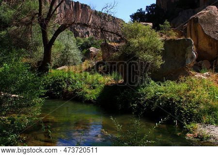 Mountain River In The Middle Of A Gorge With Mountains In The Background In The Ihlara Valley In Cap