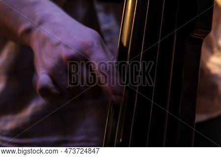 Picture Of The Hands Of A Musician Playing On A Contrabass In Pizzicato. Pizzicato Is A Playing Tech