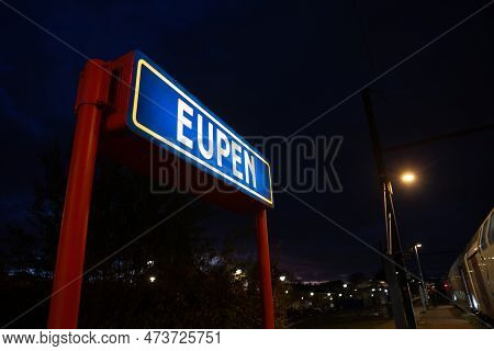 Picture Of An Eupen Sign In The Train Station, Lit At Night, Standard Of The German Railways. Eupen 