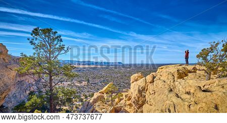 Woman Standing On Top Of Sandstone Formations At El Malpais National Monument, New Mexico.