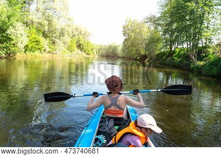 Family Kayak Trip. Mom And Daughter Rowing A Boat On The River, A Water Hike, A Summer Adventure. Ec