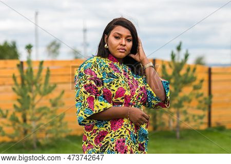 Portrait Of Beautiful African American Woman Having Fun On Village Or Suburbian. Outdoor Portrait Of