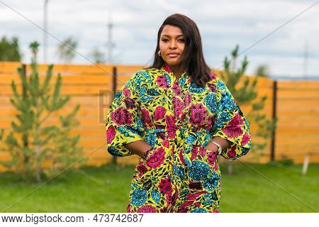 Portrait Of Beautiful African American Woman Having Fun On Village Or Suburbian. Outdoor Portrait Of